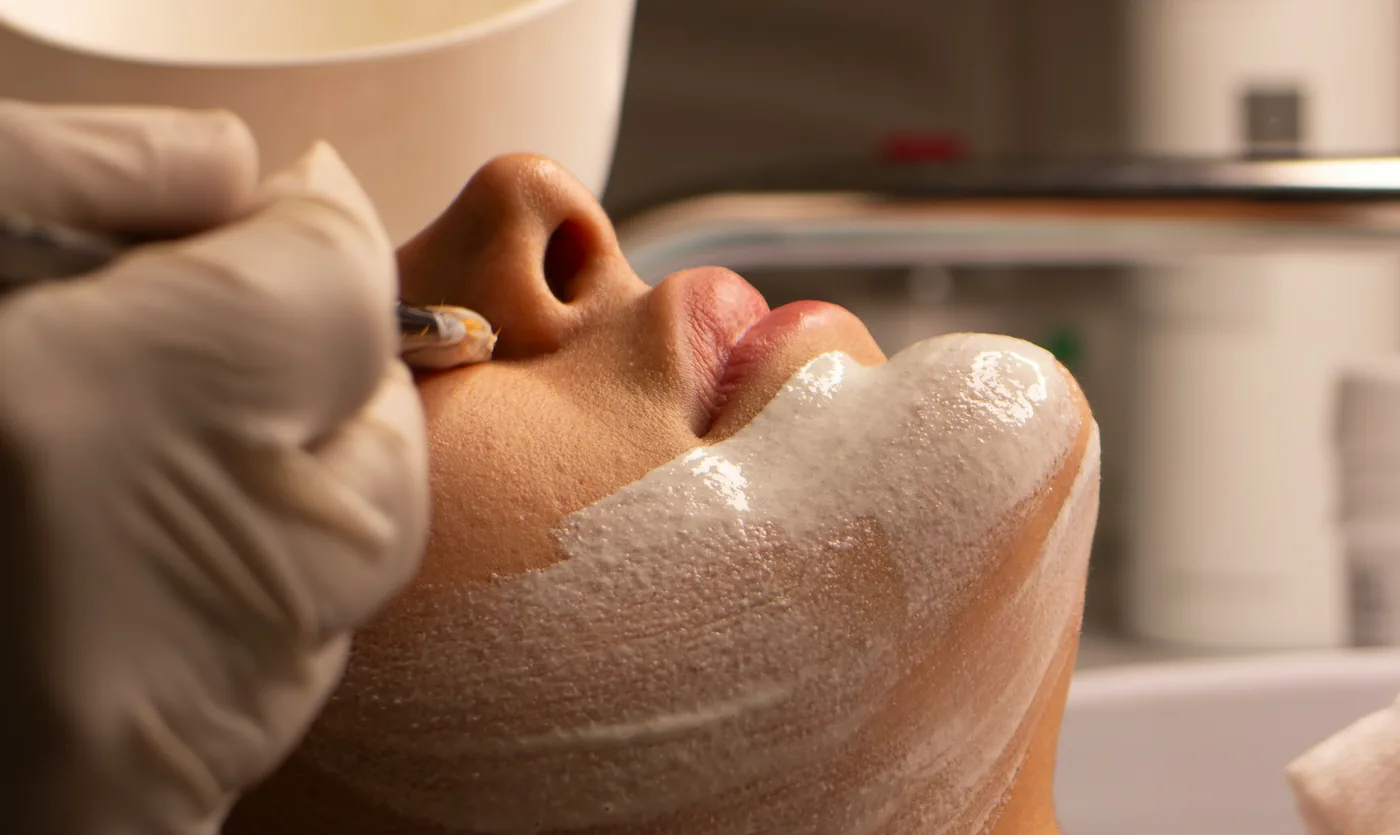 A client resting during a facial treatment with a mask applied